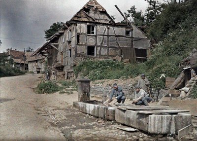 Two French soldiers assigned to a telephone station washing their laundry in a trough, Largitzen, Department Haut-Rhin, Alsace, France, June 18, 1917 by Paul Castelnau